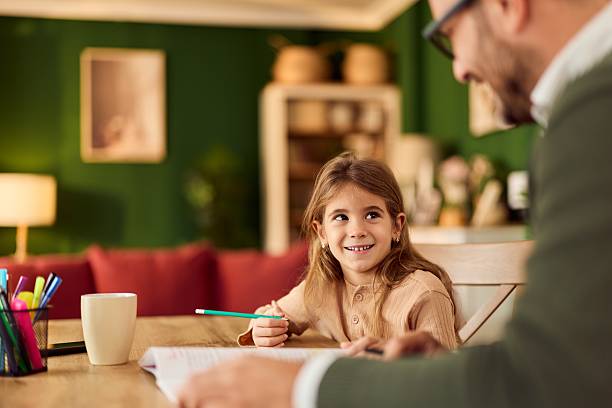 istock Child Doing Homework With Dad At Cozy Home, Warm Lighting, Focused Learning Moment 2247284994