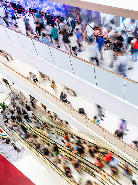 istock Crowed people in blurred motion on escalator at a shopping mall 2247285149