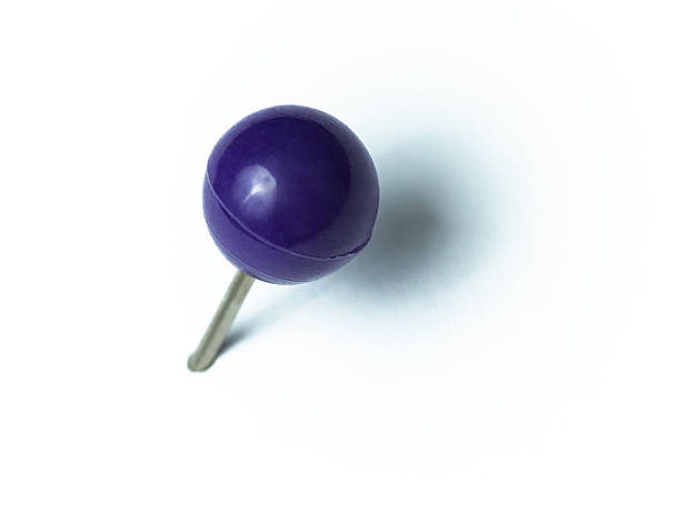 istock Round purple thumbtack with shadow on white background 2247285206