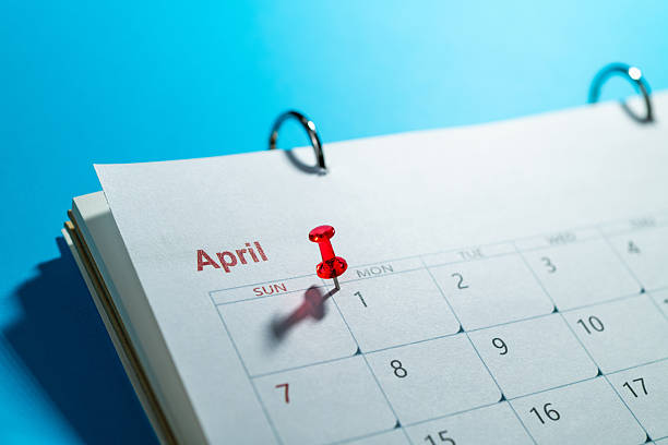 Red thumbtack on the calendar at April 1, Fools' Day