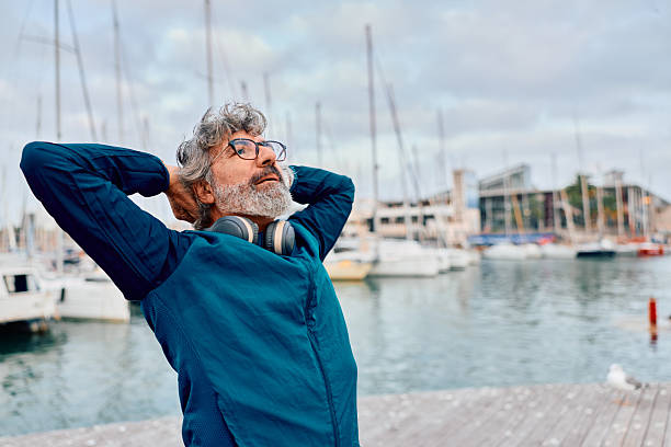 istock Mature man relaxing by harbor daydreaming on leisure trip 2247287518