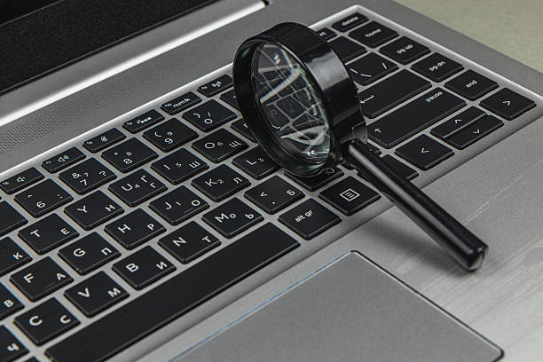 istock Magnifying glass placed on a laptop keyboard in an office setting 2247287836