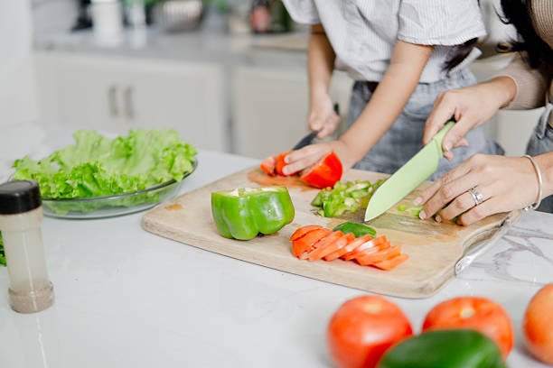 istock Mother and child preparing healthy fresh vegetables in kitchen 2247288323