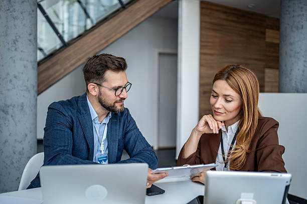 istock Business colleagues collaborating on paperwork during office meeting 2247288723