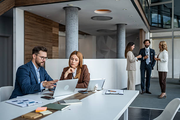 istock Professionals collaborating on laptop during business meeting in office 2247288761