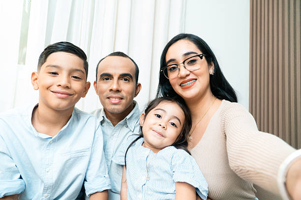 istock Happy hispanic family taking selfie at home 2247288863