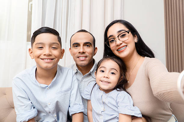 istock Happy hispanic family taking selfie at home 2247288864