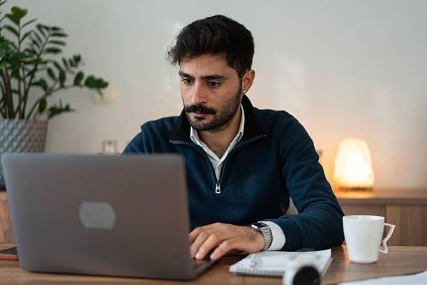 istock Focused man working on laptop in home office 2247288963