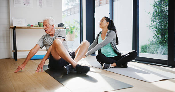 istock Stretching, physiotherapist and exercise with old man, clinic and workout to improve posture or heal. Fitness, wellness and elderly patient with woman, retirement and training for rehabilitation 2247289138
