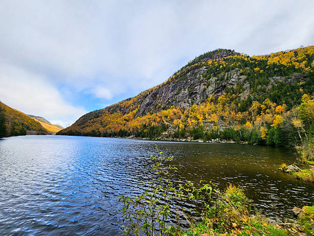 istock Adirondack lake with autumn foliage 2247290944