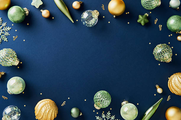 istock Luxury Christmas frame with glittering gold and green decorations on navy blue background. New Year greeting card design. 2247293354