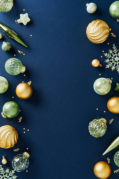 istock Vertical frame of luxury gold and green Christmas decorations on navy blue background. 2247293511