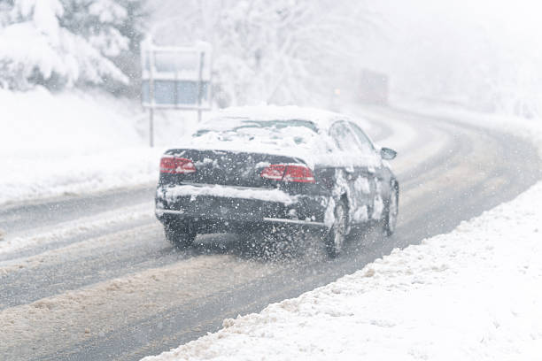 istock Snow cowered car on the winter road. 2247293766