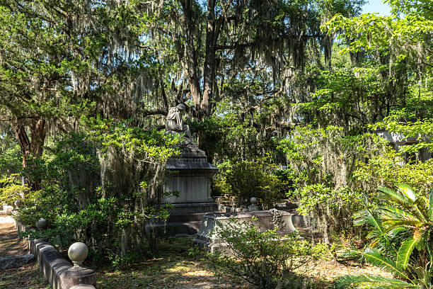 Savannah, Georgia, USA - May 25, 2025: Victorian Monument with Mourning Figure Surrounded by Spanish Moss at Bonaventure Cemetery