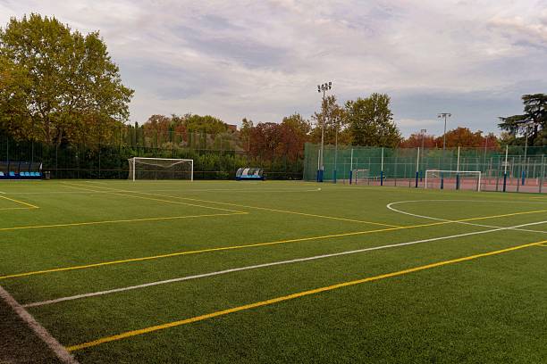 istock Empty soccer field with goalposts and surrounding sports facilities during cloudy afternoon 2247294345