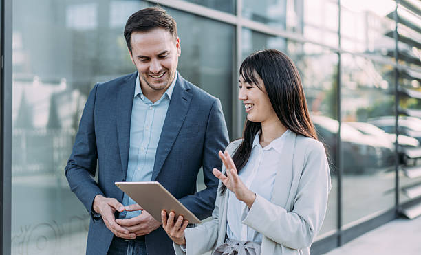 istock Business people using digital tablet outdoors. 2247294511