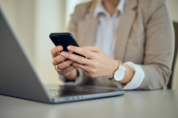 istock Professional Worker Using Smartphone and Laptop at an Office Desk 2247294847