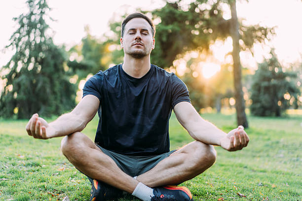 istock Man meditating in Lotus position outdoors. 2247294902