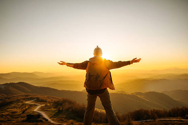 istock Back view woman with arms wide open in mountain sunset 2247296102
