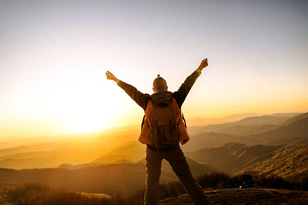 istock Back view woman with arms wide open in mountain sunset 2247296138