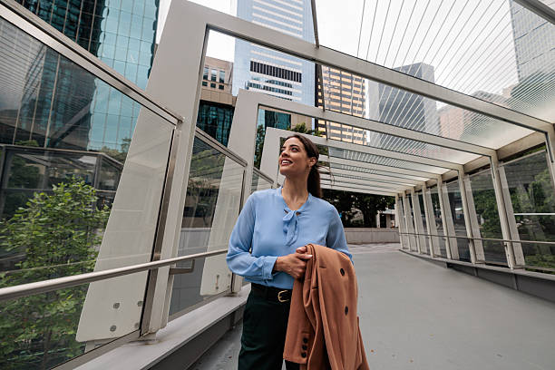 istock Confident Businesswoman Walking Through Modern Cityscape 2247297422