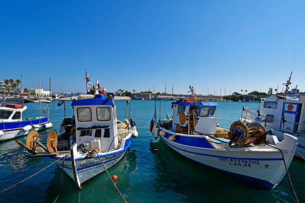 Boats docked in a harbor on a sunny day with clear blue sky on the Greek island of Kos