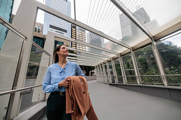 istock Confident Businesswoman Walking Through Modern Cityscape 2247297460