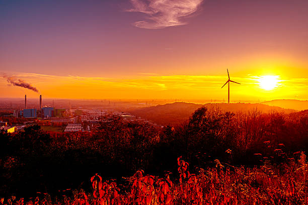 istock The sky explodes in a warm, deep orange red, while the sun itself presses like a glowing stamp on the horizon. In the foreground, the autumn leaves dance in fiery shades of red, a reflection of the celestial glow. 2247299023