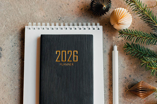 istock Stylish Desk Setup With 2026 Planner, Notebook, Pencil, Fir tree Branch on Table 2247299101