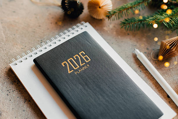 istock Stylish Desk Setup With 2026 Planner, Notebook, Pencil, Fir tree Branch on Table 2247299105