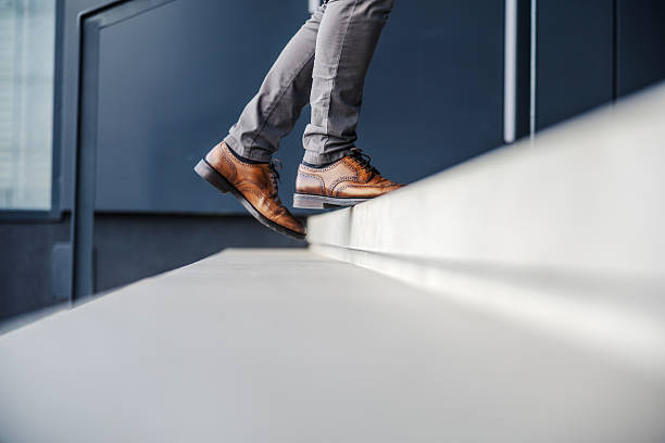 istock Business person walking up stairs achieving career success 2247299516