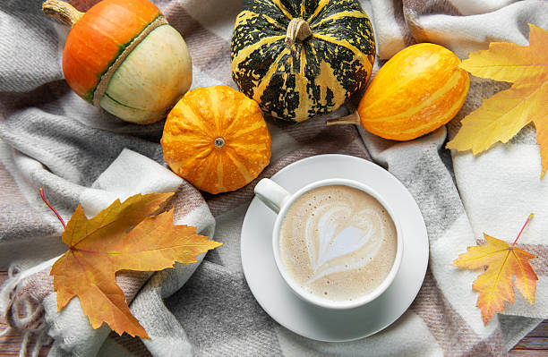 istock Warm coffee with latte art and autumn pumpkins 2247300439