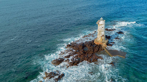 Mangiabarche lighthouse on rocky coast near Calasetta Sardinia