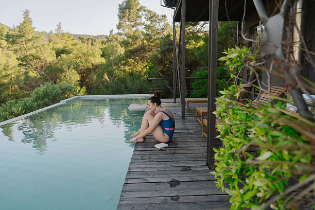 istock Young woman relaxing by the infinity pool 2247303325