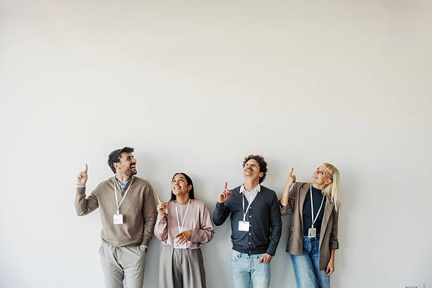 istock Business people pointing up looking at copy space 2247304294