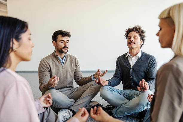 istock Coworkers meditating together in an office workshop 2247304312
