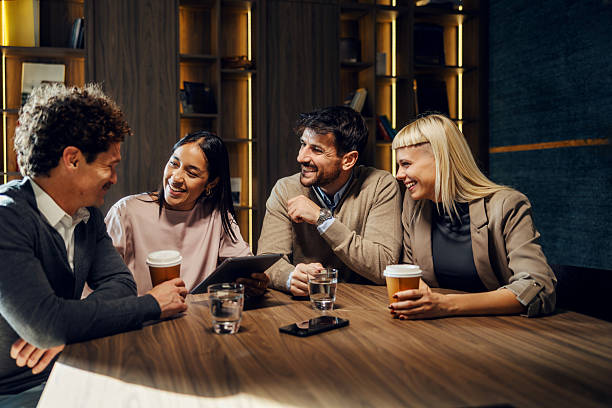 istock Diverse colleagues laughing during business coffee break looking at tablet 2247304377