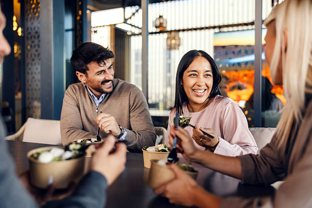 istock Business colleagues having lunch break and laughing at restaurant 2247304404