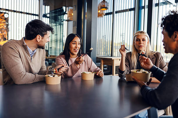 istock Diverse coworkers having lunch break together in modern office 2247304413