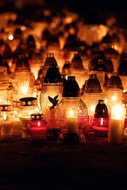 istock Lit cemetery candles glowing in the dark 2247305148
