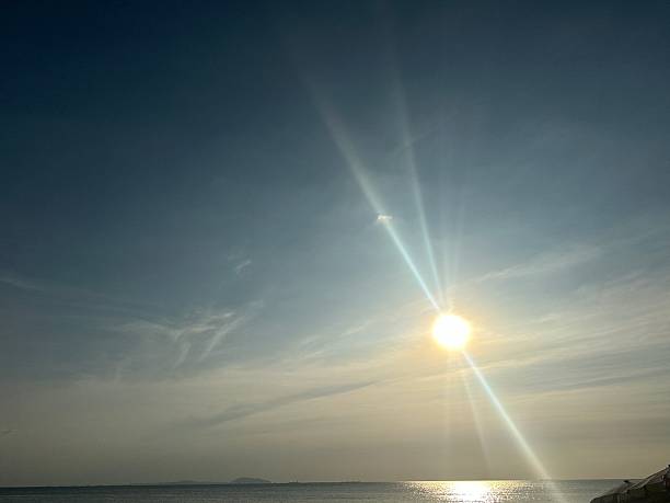 istock Stunning Sunrise Over Calm Ocean Waters with Bright Sunlight and Soft Clouds on Clear Horizon Ideal for Tranquil Nature and Seascape Themes 2247306158