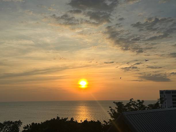 istock Serene Ocean Sunset Over Calm Waters with Orange and Yellow Hues Reflecting on the Surface Against a Beautiful Sky 2247306311