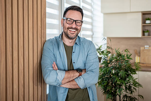 istock Happy confident man smiling in modern home 2247307844