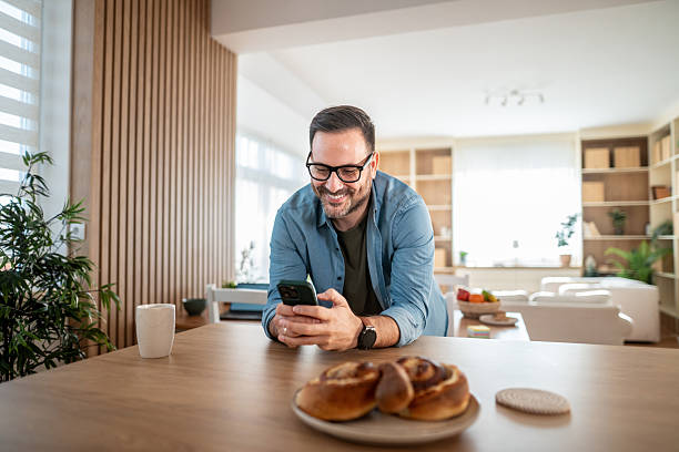 istock Happy adult man checking smartphone at home 2247309202