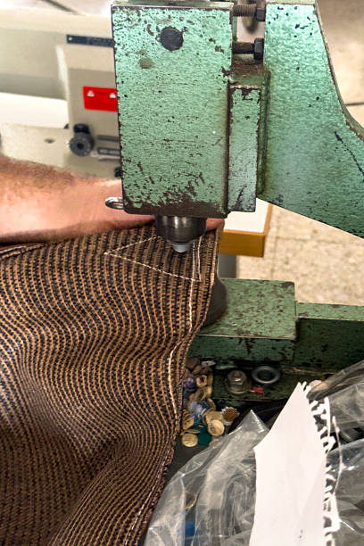 istock Closeup of grommet being pressed into industrial fabric using manual press 2247313302