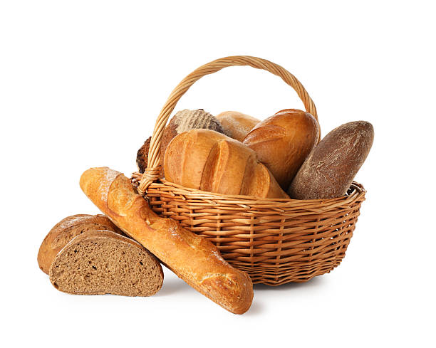 istock Different freshly baked bread loafs in wicker basket isolated on white 2247314768