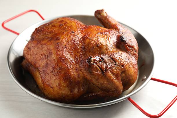 istock Delicious baked turkey in baking dish on light table, closeup 2247315800