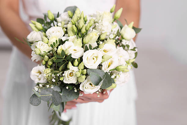 istock Bride with beautiful wedding bouquet on light background, closeup 2247316153