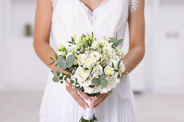 istock Bride with beautiful wedding bouquet on light background, closeup 2247316169