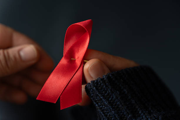 istock Hands holding red AIDS awareness ribbon 2247316460
